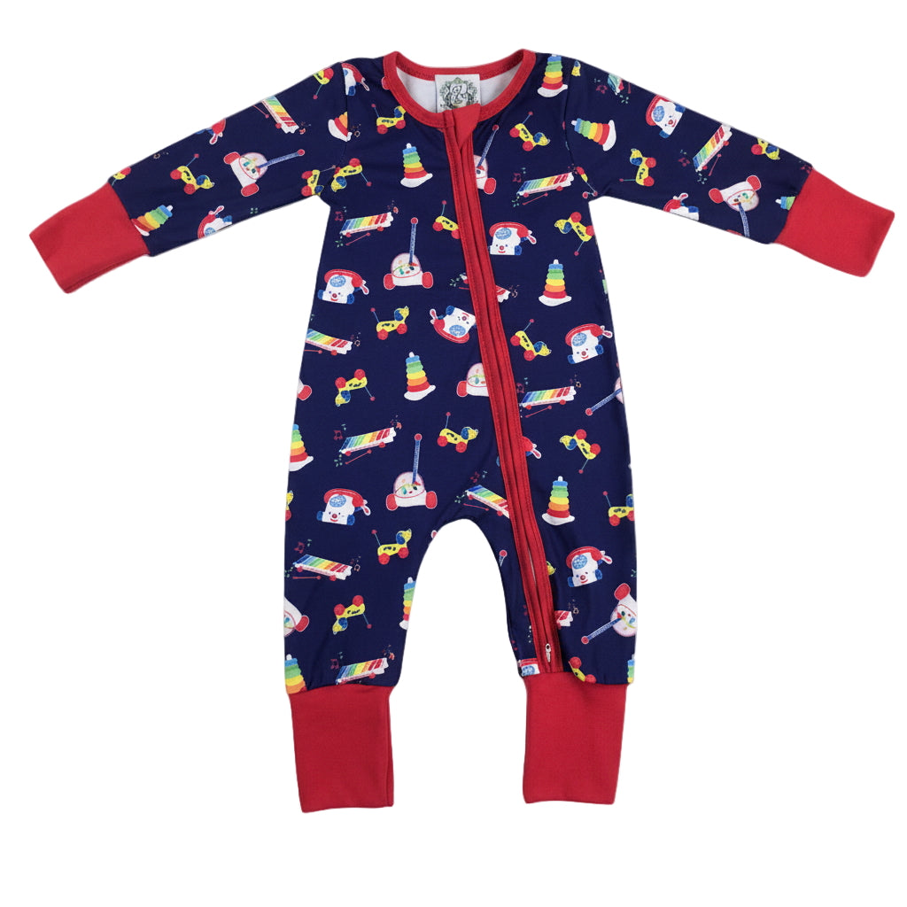Baby boy blue zippy romper with vintage 80s 90s toy print including chattering teeth, telephone, and stacking rings.