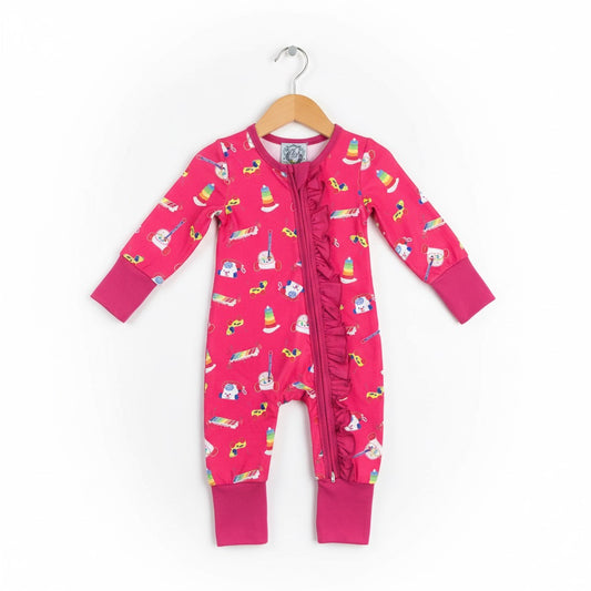 Girls vintage 80s 90s toy print ruffle zippy footless sleeper romper hanging on wooden coat hanger.