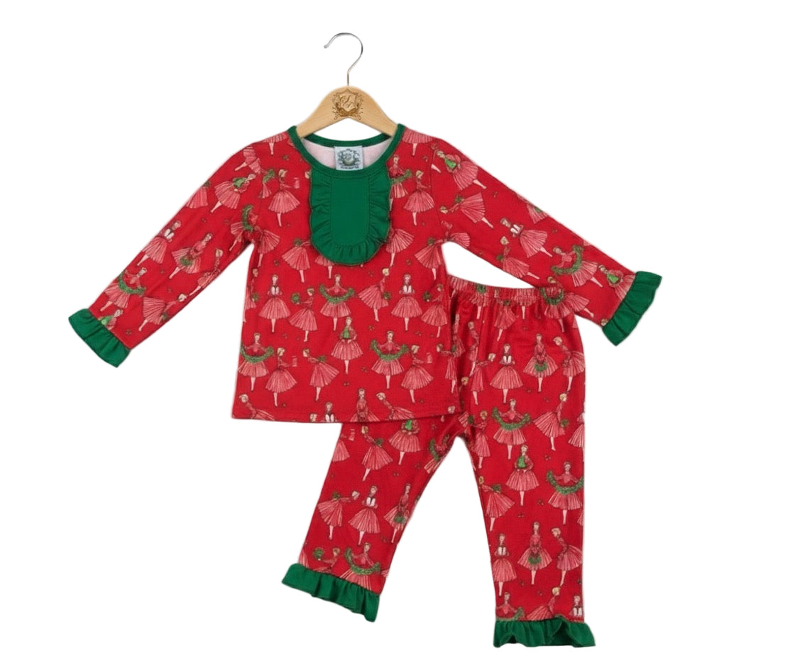 Vintage Christmas lady icons girls red pajama set with green ruffle collar displayed on a wooden hanger.