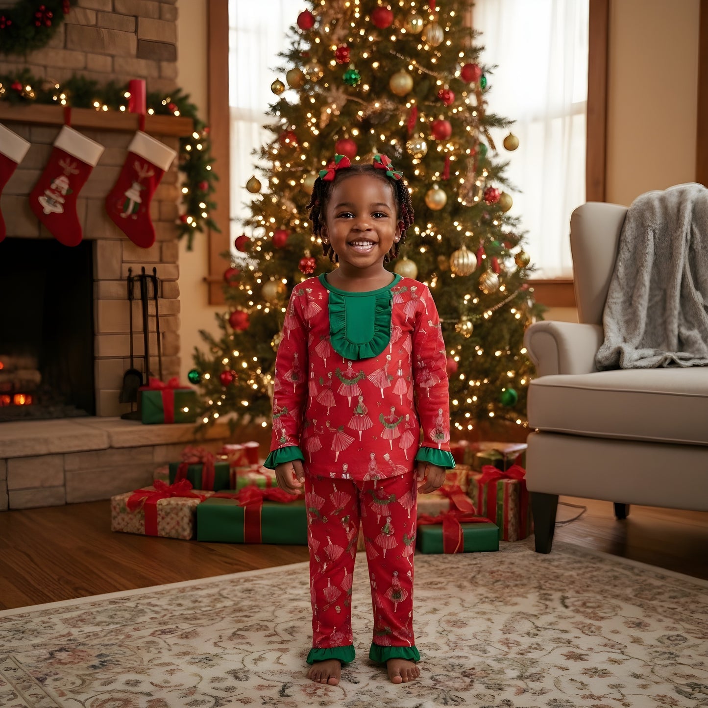 Toddler girl wearing Vintage Christmas Lady Icons red pajama set with green ruffle trim standing by tree.